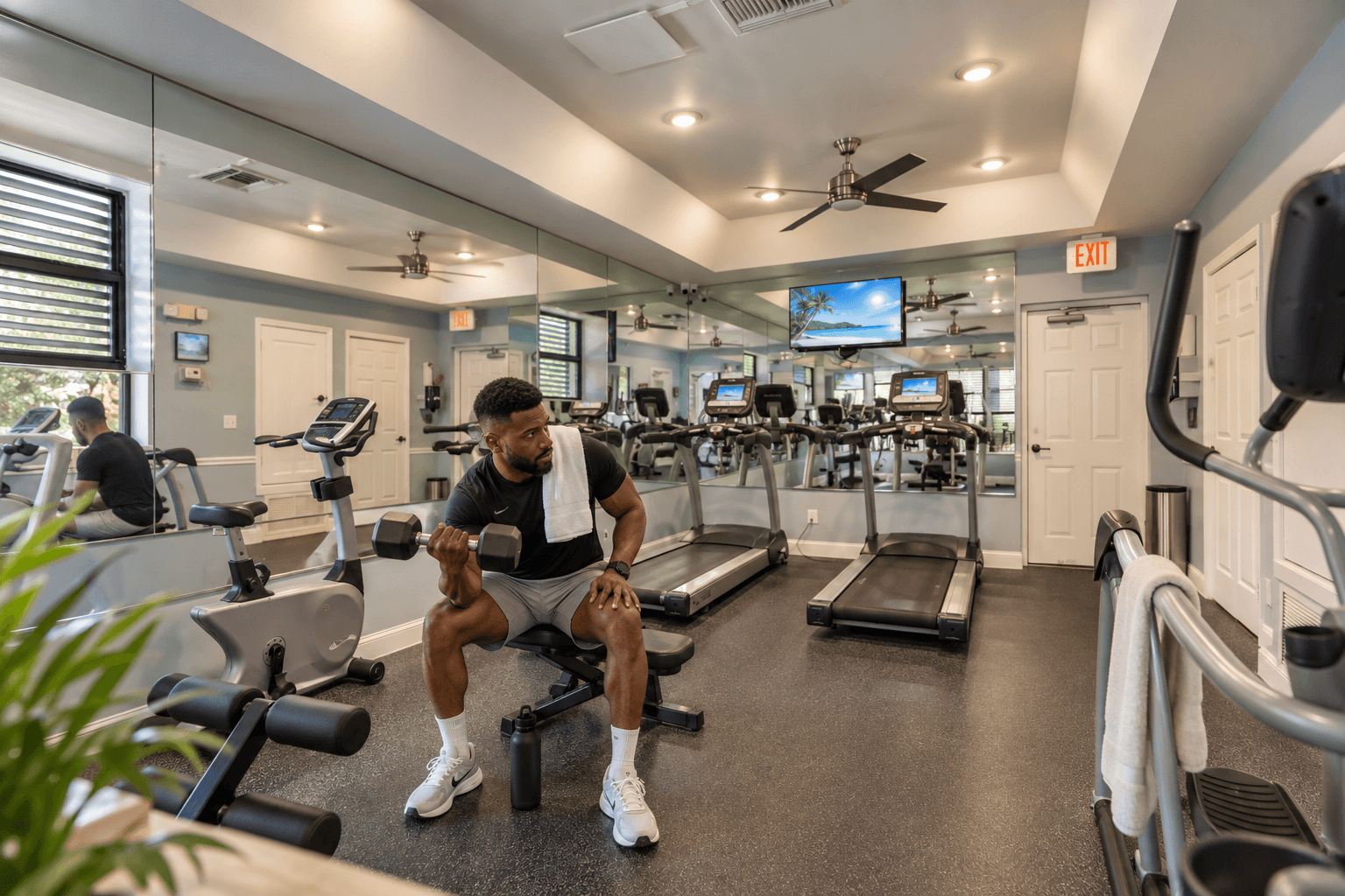 A man is working out in a gym with a variety of equipment.
